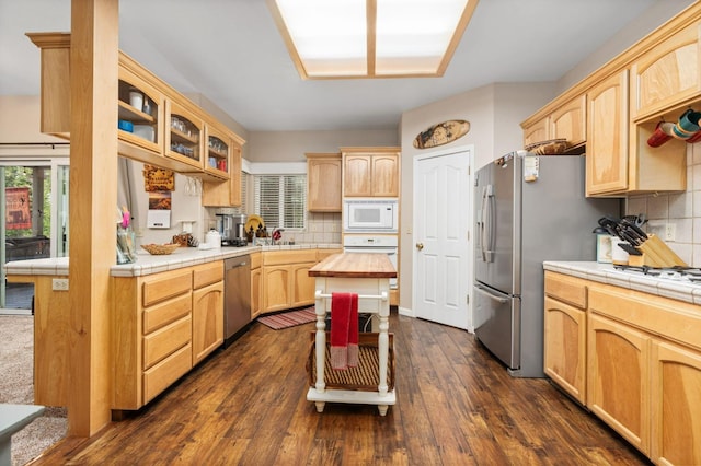 41208 Silver Pine Ln, Shaver Lake, CA 93664 - kitchen with appliances with stainless steel finishes, light brown cabinetry, glass insert cabinets, and decorative backsplash