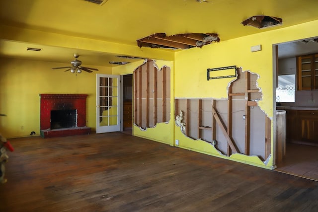 1315 W Fedora Ave, Fresno, CA 93705 - unfurnished living room featuring wood finished floors, a ceiling fan, and a brick fireplace
