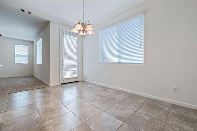 3834 Sussex Ave, Clovis, CA 93619 - unfurnished dining area with a chandelier, baseboards, and tile patterned flooring