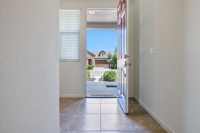 3834 Sussex Ave, Clovis, CA 93619 - entryway featuring baseboards, healthy amount of natural light, tile patterned floors, and a textured wall