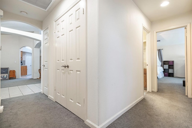 2903 Desert Ranch Way, Madera, CA 93637 - hallway with carpet floors, arched walkways, baseboards, and tile patterned flooring