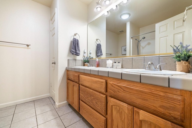2903 Desert Ranch Way, Madera, CA 93637 - bathroom with double vanity, tile patterned flooring, baseboards, and a shower
