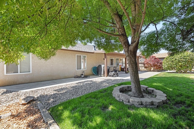 2903 Desert Ranch Way, Madera, CA 93637 - rear view of house with stucco siding, a patio, and a yard