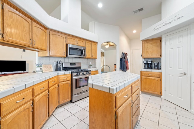 2903 Desert Ranch Way, Madera, CA 93637 - kitchen with stainless steel appliances, light tile patterned flooring, decorative backsplash, recessed lighting, and tile countertops