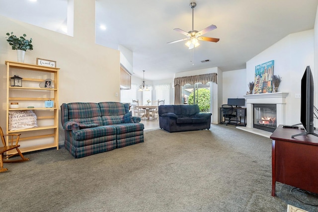 2903 Desert Ranch Way, Madera, CA 93637 - living room with carpet floors, a glass covered fireplace, a ceiling fan, vaulted ceiling, and a chandelier