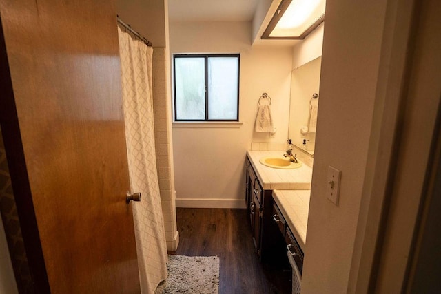 1603 E Serena Ave, Fresno, CA 93720 - full bath with vanity, wood finished floors, a shower with curtain, and baseboards