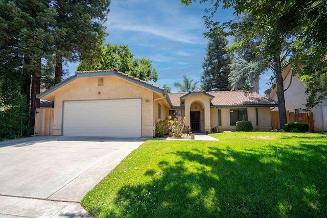 1603 E Serena Ave, Fresno, CA 93720 - mediterranean / spanish-style home featuring a tiled roof, an attached garage, driveway, and stucco siding