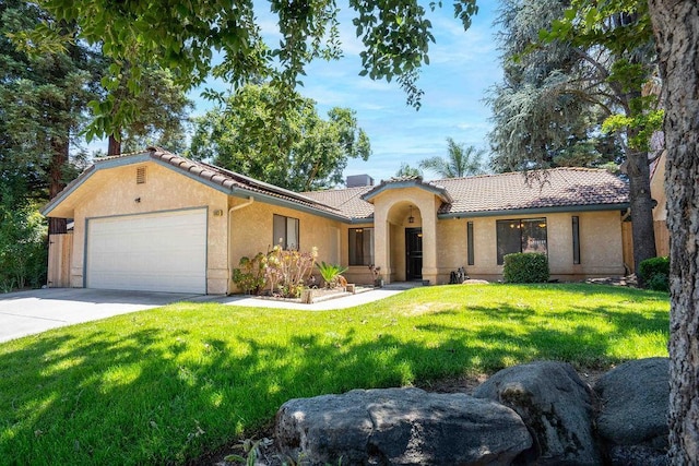 1603 E Serena Ave, Fresno, CA 93720 - view of front of home featuring a tiled roof, an attached garage, stucco siding, concrete driveway, and a front lawn