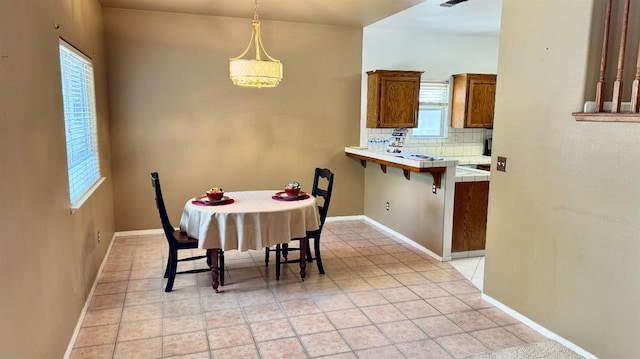 5346 W Flint Way, Fresno, CA 93722 - dining area with baseboards and light tile patterned floors