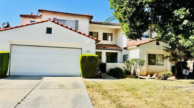 5346 W Flint Way, Fresno, CA 93722 - mediterranean / spanish home featuring a tiled roof, driveway, stucco siding, a garage, and a front yard