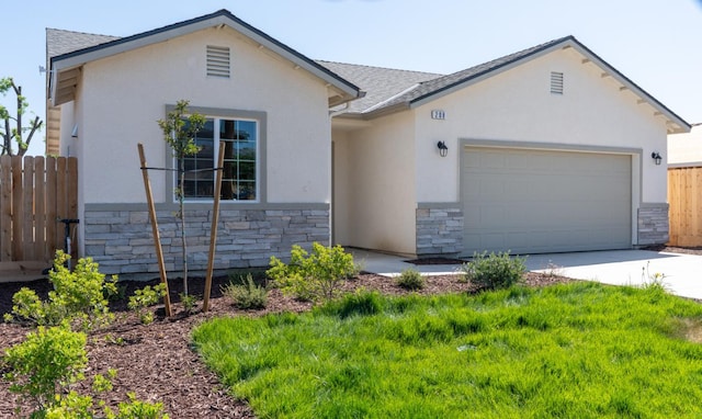 43 E Florence Ave, Fresno, CA 93706 - view of front of property featuring stone siding, stucco siding, an attached garage, and concrete driveway