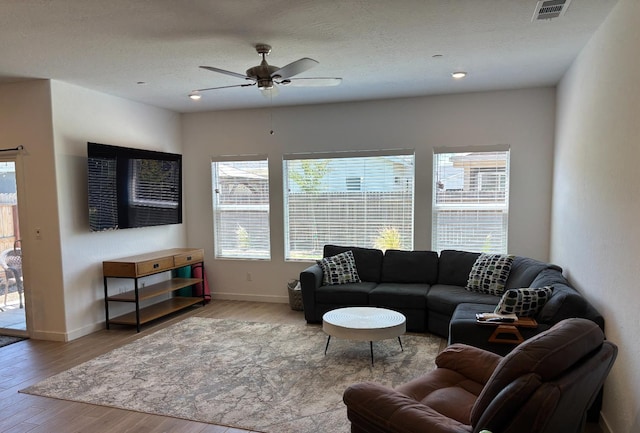 6423 E Robinson, Fresno, CA 93727 - living area with ceiling fan, wood finished floors, and baseboards