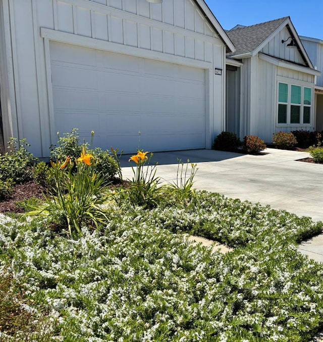 6423 E Robinson, Fresno, CA 93727 - view of front of house with board and batten siding, concrete driveway, roof with shingles, and an attached garage