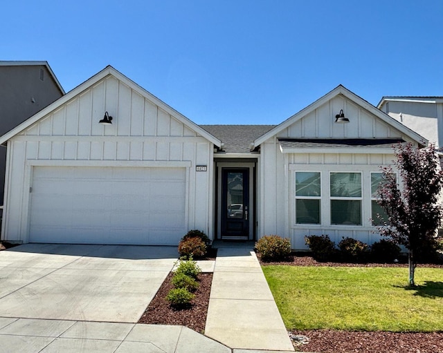 6423 E Robinson, Fresno, CA 93727 - view of front of home with board and batten siding, a front yard, an attached garage, concrete driveway, and roof with shingles