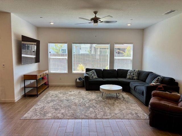 6423 E Robinson, Fresno, CA 93727 - living area with wood finished floors, a ceiling fan, healthy amount of natural light, and baseboards