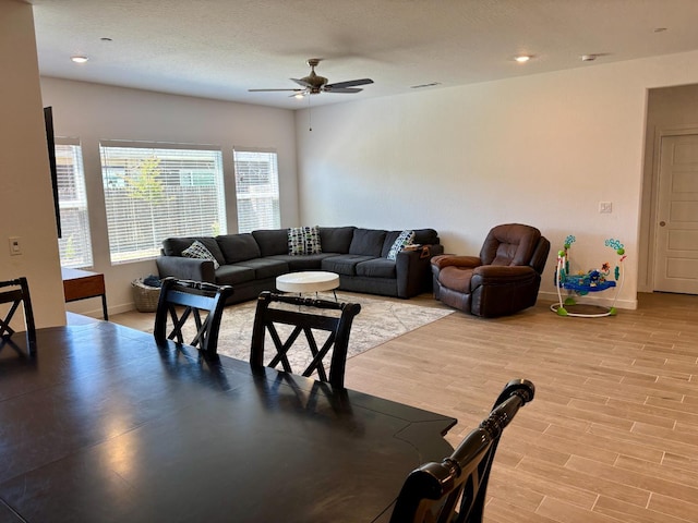 6423 E Robinson, Fresno, CA 93727 - living room with ceiling fan, light wood-style floors, and baseboards
