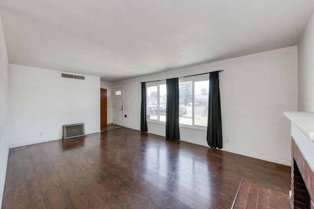 1205 W Clinton Ave, Fresno, CA 93705 - unfurnished living room featuring wood finished floors, a brick fireplace, and baseboards