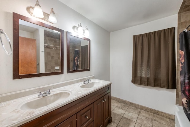 1205 W Clinton Ave, Fresno, CA 93705 - bathroom with double vanity, a shower with shower curtain, tile patterned floors, and baseboards