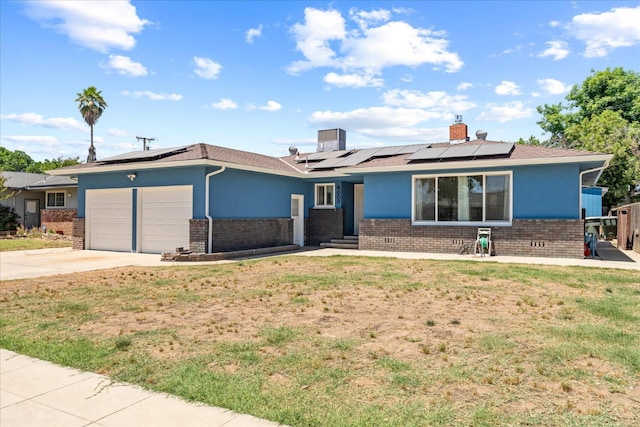 4003 E Fedora Ave, Fresno, CA 93726 - single story home featuring brick siding, a garage, solar panels, and a front lawn