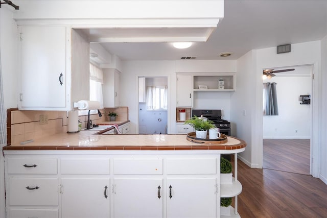 4003 E Fedora Ave, Fresno, CA 93726 - kitchen with gas stove, dark wood finished floors, white cabinetry, and a peninsula