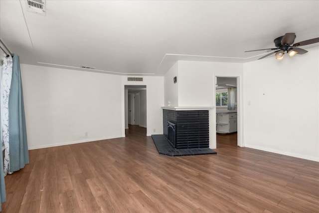 4003 E Fedora Ave, Fresno, CA 93726 - unfurnished living room with wood finished floors, a ceiling fan, and baseboards