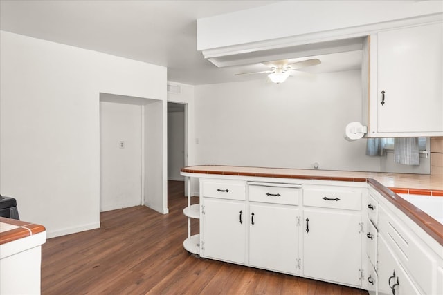 4003 E Fedora Ave, Fresno, CA 93726 - kitchen with tile countertops, white cabinetry, ceiling fan, dark wood-style flooring, and a peninsula