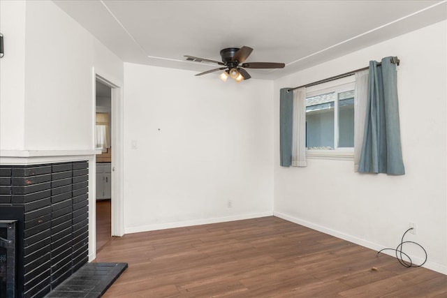 4003 E Fedora Ave, Fresno, CA 93726 - unfurnished living room with wood finished floors, a ceiling fan, baseboards, and a brick fireplace