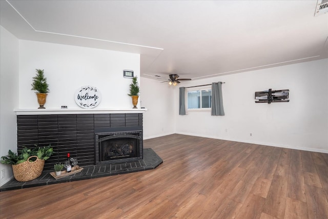 4003 E Fedora Ave, Fresno, CA 93726 - unfurnished living room featuring wood finished floors, ceiling fan, and a fireplace