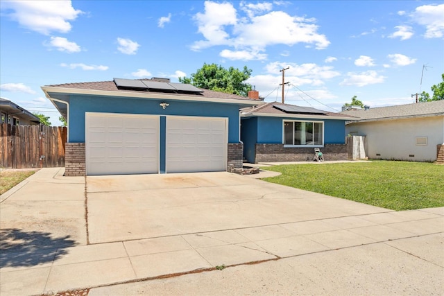 4003 E Fedora Ave, Fresno, CA 93726 - view of front of home with brick siding, an attached garage, roof mounted solar panels, concrete driveway, and stucco siding