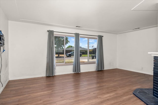 4003 E Fedora Ave, Fresno, CA 93726 - unfurnished living room with wood finished floors, a brick fireplace, and baseboards