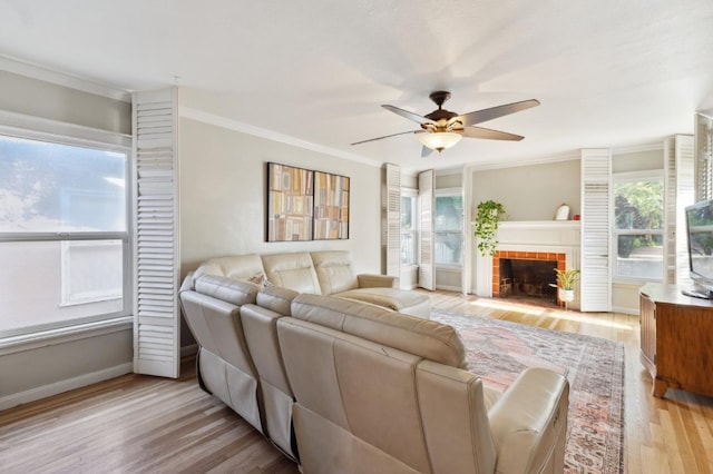 315 E Clinton Ave, Fresno, CA 93704 - living room featuring ceiling fan, crown molding, light wood-type flooring, baseboards, and a tile fireplace