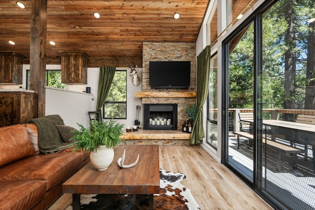 41831 Saddleback Rd, Shaver Lake, CA 93664 - living area with wooden ceiling, wood finished floors, a stone fireplace, vaulted ceiling, and recessed lighting
