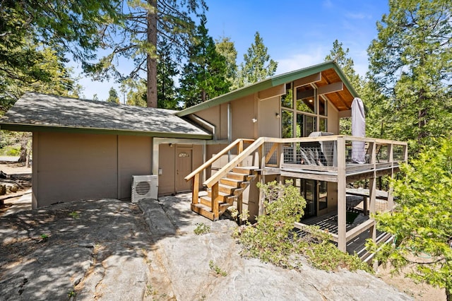 41831 Saddleback Rd, Shaver Lake, CA 93664 - view of front of home with a cooling unit, a deck, stairs, and a shingled roof