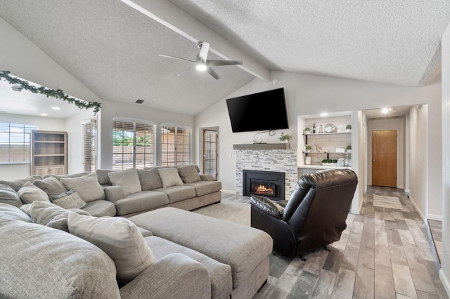 1958 Sundance Ln, Madera, CA 93637 - living area featuring a textured ceiling, light wood-type flooring, a tile fireplace, ceiling fan, and baseboards