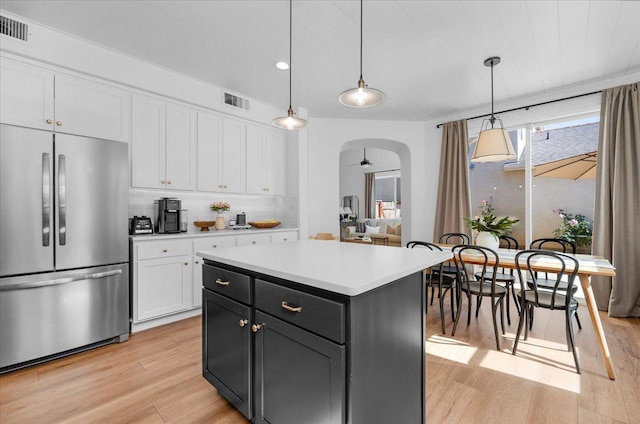 1780 N Avignon Ln, Clovis, CA 93619 - kitchen with high quality fridge, light wood finished floors, white cabinetry, arched walkways, and recessed lighting