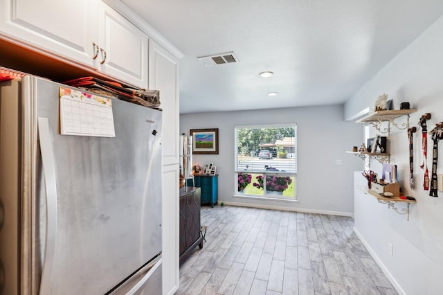 119 Magnolia Ave, Lemoore, CA 93245 - kitchen with freestanding refrigerator, white cabinetry, light wood-style floors, baseboards, and recessed lighting