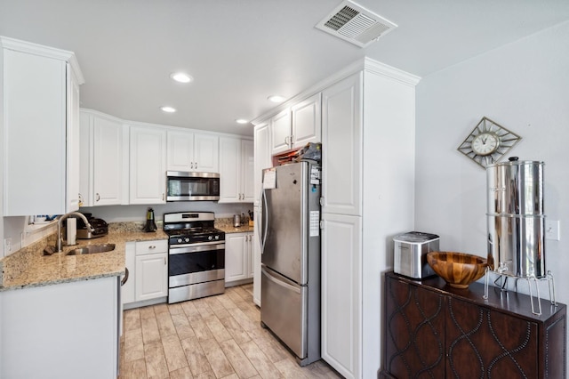 119 Magnolia Ave, Lemoore, CA 93245 - kitchen featuring stainless steel appliances, a sink, white cabinetry, and recessed lighting