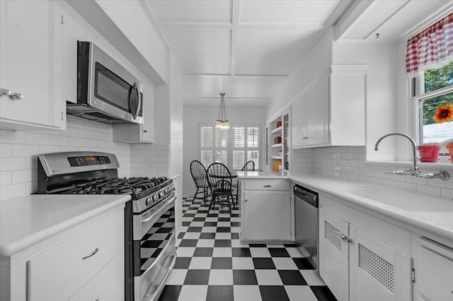 739 E Harvard Ave, Fresno, CA 93704 - kitchen featuring stainless steel appliances, a sink, dark flooring, white cabinets, and light countertops