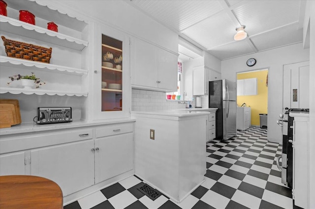 739 E Harvard Ave, Fresno, CA 93704 - kitchen featuring light floors, appliances with stainless steel finishes, light countertops, washer / dryer, and white cabinetry
