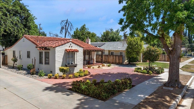 739 E Harvard Ave, Fresno, CA 93704 - mediterranean / spanish-style home with a tile roof, stucco siding, and a chimney
