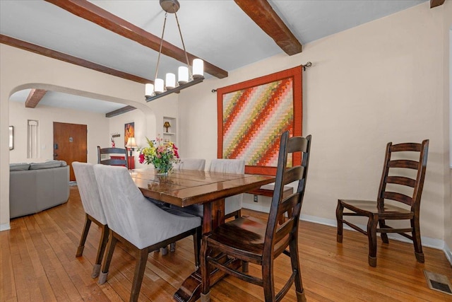 739 E Harvard Ave, Fresno, CA 93704 - dining room with arched walkways, beam ceiling, light wood-type flooring, and baseboards