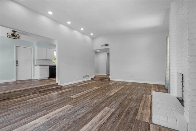 6569 N Kennedy Ave, Fresno, CA 93710 - unfurnished living room with recessed lighting, dark wood finished floors, lofted ceiling, and baseboards