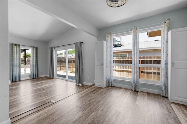 6569 N Kennedy Ave, Fresno, CA 93710 - spare room with lofted ceiling, wood finished floors, and baseboards