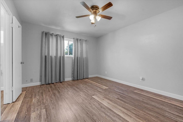 6569 N Kennedy Ave, Fresno, CA 93710 - empty room with a ceiling fan, wood finished floors, and baseboards