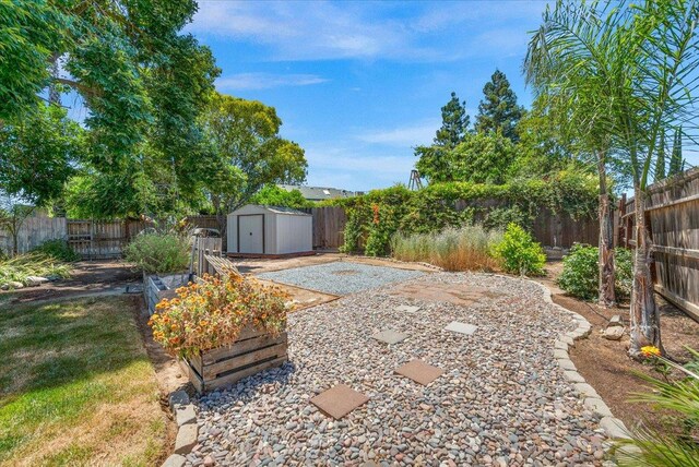 6569 N Kennedy Ave, Fresno, CA 93710 - fenced backyard with a patio area and a vegetable garden