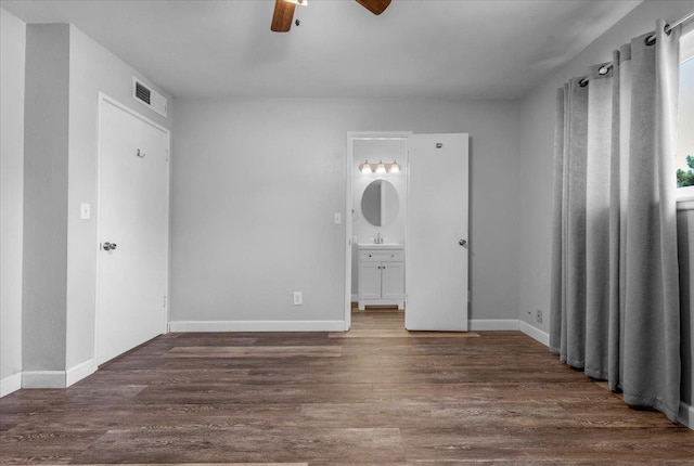 6569 N Kennedy Ave, Fresno, CA 93710 - unfurnished bedroom with wood finished floors, ensuite bath, and baseboards