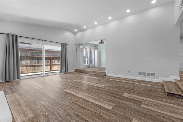 6569 N Kennedy Ave, Fresno, CA 93710 - unfurnished living room with recessed lighting, wood finished floors, lofted ceiling, and baseboards