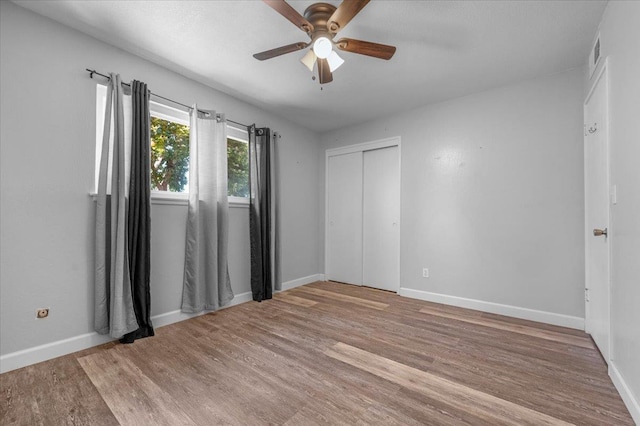 6569 N Kennedy Ave, Fresno, CA 93710 - unfurnished bedroom featuring wood finished floors, a closet, and baseboards
