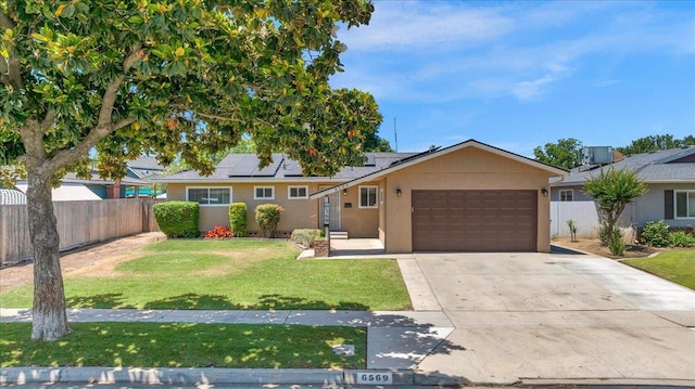 6569 N Kennedy Ave, Fresno, CA 93710 - ranch-style house featuring an attached garage, stucco siding, roof mounted solar panels, and concrete driveway