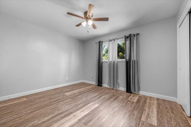 6569 N Kennedy Ave, Fresno, CA 93710 - empty room featuring ceiling fan, wood finished floors, and baseboards